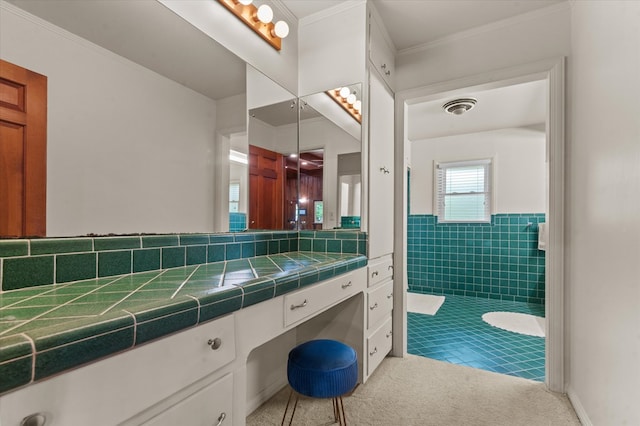 915 Evans Dr, Lufkin, TX 75904 - bathroom featuring vanity, tile walls, ornamental molding, and a wainscoted wall