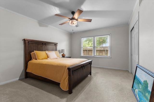 915 Evans Dr, Lufkin, TX 75904 - bedroom with light colored carpet, ornamental molding, ceiling fan, and a closet