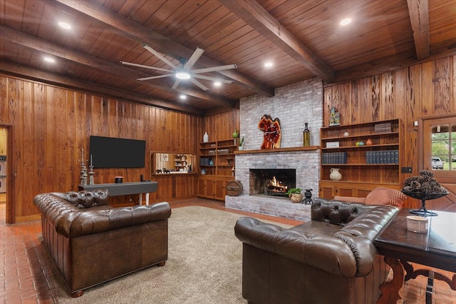 915 Evans Dr, Lufkin, TX 75904 - living room featuring wood walls, a wooden ceiling with exposed beams, a fireplace, and a ceiling fan