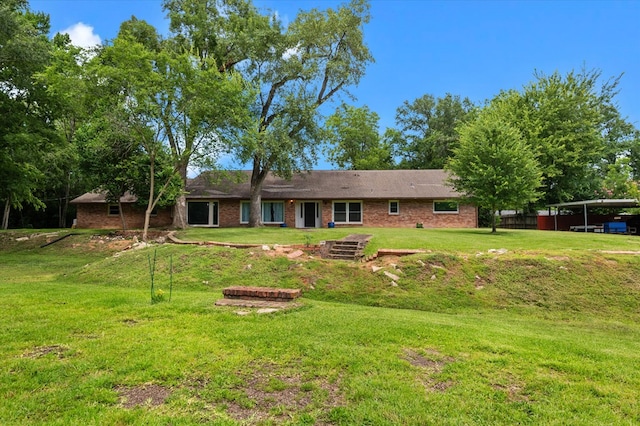 915 Evans Dr, Lufkin, TX 75904 - back of property featuring a yard and brick siding