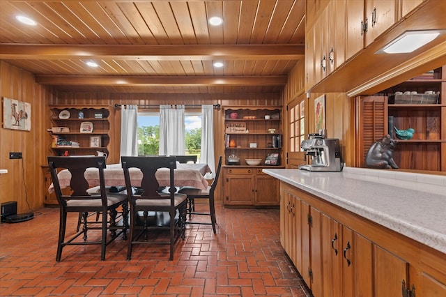 915 Evans Dr, Lufkin, TX 75904 - dining space featuring a wood ceiling with exposed beams, brick flooring, wood walls, and recessed lighting