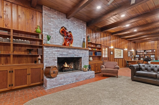 915 Evans Dr, Lufkin, TX 75904 - living area featuring wood walls, a fireplace, and a wood ceiling with exposed beams