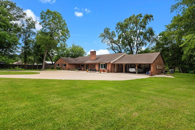 915 Evans Dr, Lufkin, TX 75904 - rear view of property with driveway, a chimney, a yard, brick siding, and a carport