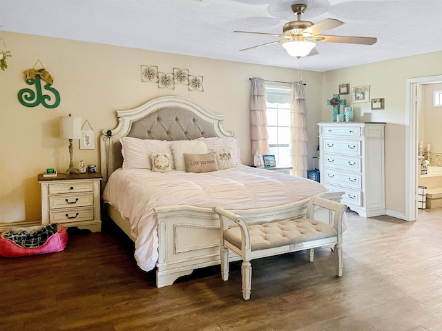 bedroom with ceiling fan, ensuite bathroom, and wood-type flooring