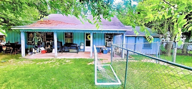 back of house with a yard and a patio area