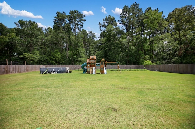 169 Shady Oaks Loop, Lufkin, TX 75904 - fenced backyard featuring a playground