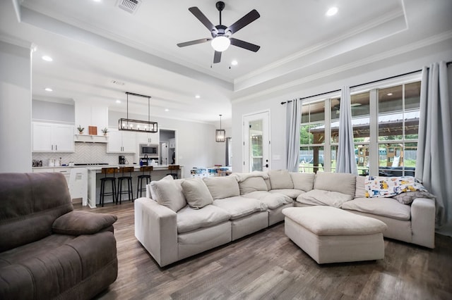 169 Shady Oaks Loop, Lufkin, TX 75904 - living room featuring dark wood finished floors, a ceiling fan, recessed lighting, a raised ceiling, and crown molding