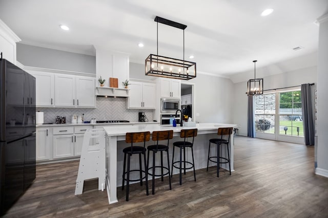 169 Shady Oaks Loop, Lufkin, TX 75904 - kitchen featuring stainless steel appliances, a chandelier, tasteful backsplash, a kitchen island with sink, and light countertops