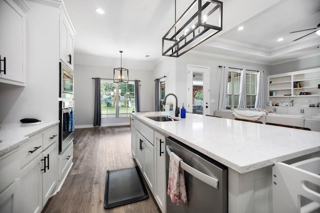 169 Shady Oaks Loop, Lufkin, TX 75904 - kitchen featuring appliances with stainless steel finishes, dark wood-style floors, a center island with sink, white cabinets, and crown molding