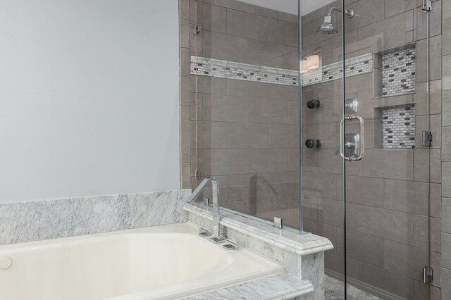 bathroom featuring separate shower and tub