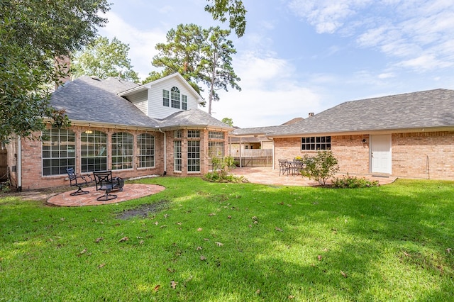 back of property featuring a yard and a patio