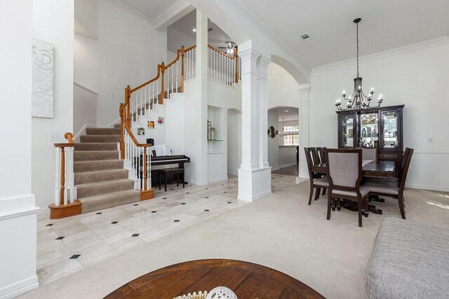 dining space with an inviting chandelier, tile patterned floors, ornamental molding, and ornate columns