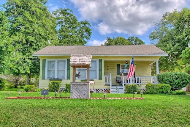 view of front of property with a front yard and a porch