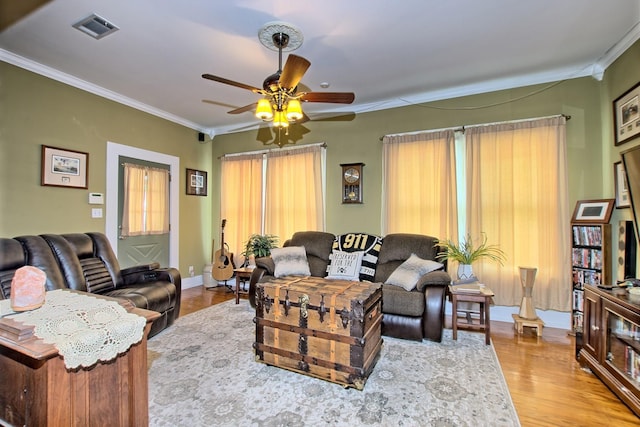 living room with ceiling fan, light hardwood / wood-style floors, and ornamental molding