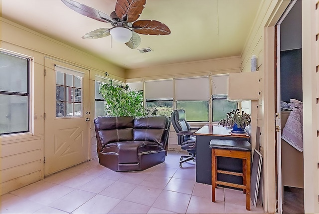 interior space with ceiling fan and crown molding