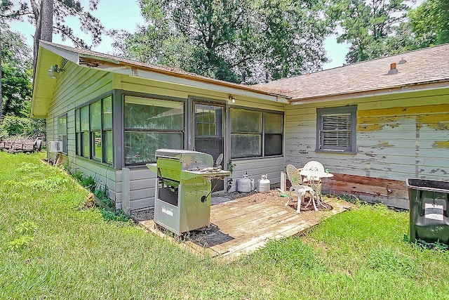 rear view of house featuring a yard