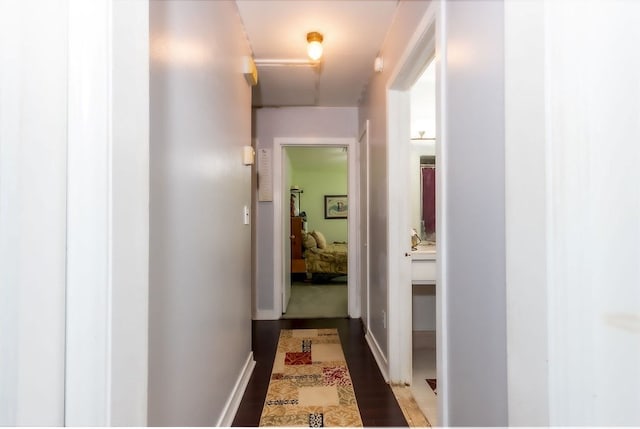 hallway featuring dark wood-type flooring