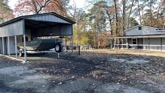 view of yard with driveway and a detached carport