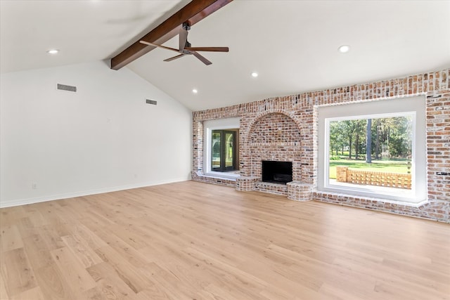 unfurnished living room with vaulted ceiling with beams, light wood-type flooring, a wealth of natural light, and ceiling fan