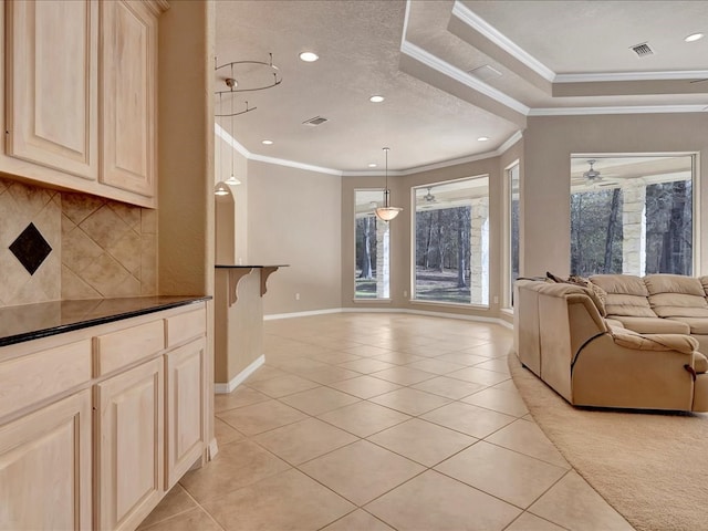 living area featuring baseboards, ornamental molding, visible vents, and light tile patterned floors