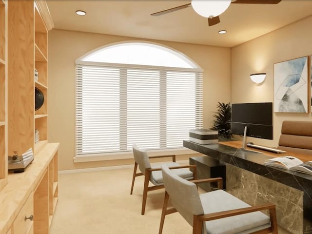 office featuring ceiling fan, light carpet, and baseboards