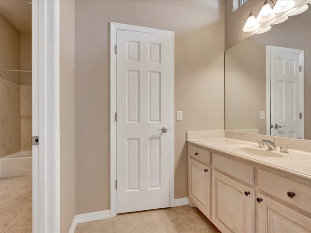 bathroom featuring tile patterned floors, baseboards, and vanity