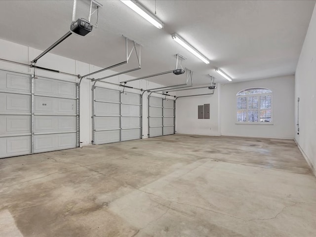 garage featuring electric panel and a garage door opener