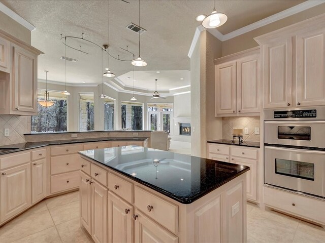 kitchen featuring double oven, visible vents, ornamental molding, and light tile patterned floors
