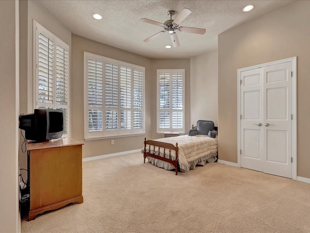 bedroom with baseboards, carpet flooring, recessed lighting, and a textured ceiling