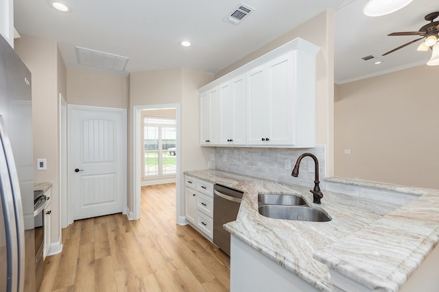 211 Rustic Pines Dr, Lufkin, TX 75904 - kitchen featuring appliances with stainless steel finishes, white cabinets, light wood finished floors, a ceiling fan, and light stone counters