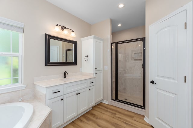 211 Rustic Pines Dr, Lufkin, TX 75904 - bathroom with a shower stall, a garden tub, vanity, wood finished floors, and recessed lighting