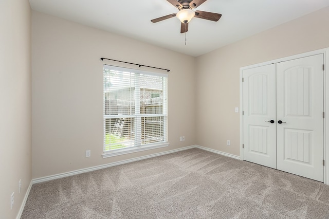 211 Rustic Pines Dr, Lufkin, TX 75904 - unfurnished bedroom with carpet floors, multiple windows, a closet, and a ceiling fan