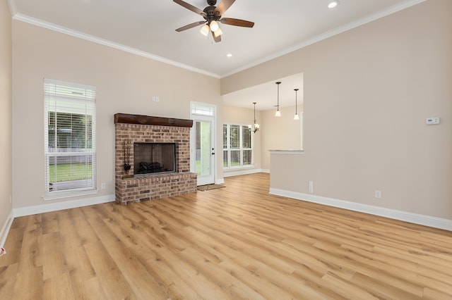 211 Rustic Pines Dr, Lufkin, TX 75904 - unfurnished living room with ceiling fan, light wood-style flooring, ornamental molding, a fireplace, and recessed lighting