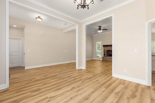211 Rustic Pines Dr, Lufkin, TX 75904 - unfurnished room with crown molding, light wood-type flooring, a brick fireplace, a chandelier, and ceiling fan