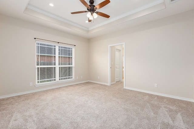 211 Rustic Pines Dr, Lufkin, TX 75904 - spare room featuring a tray ceiling, crown molding, light carpet, ceiling fan, and recessed lighting