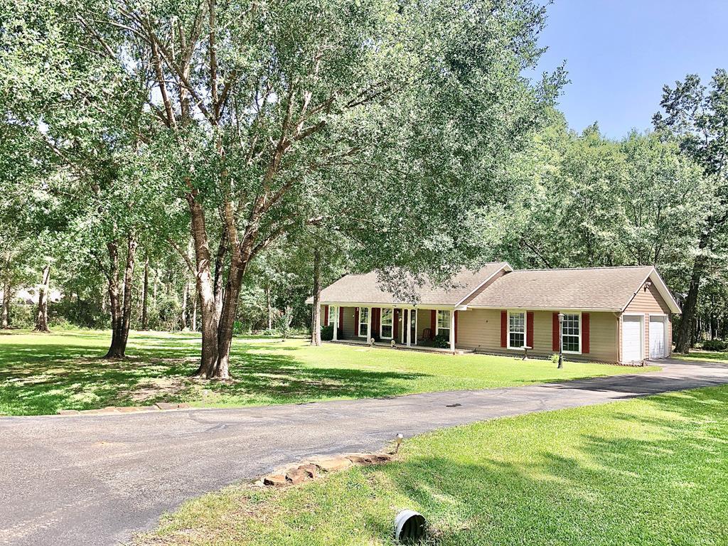 ranch-style home featuring a garage and a front lawn