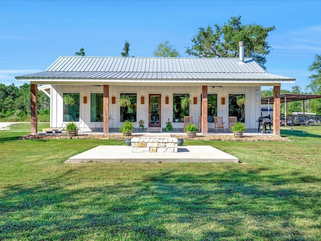 rear view of house featuring a lawn