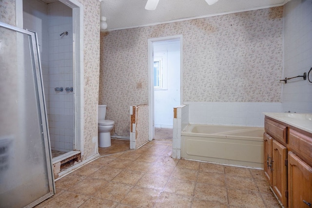 full bath featuring a stall shower, vanity, toilet, and wallpapered walls