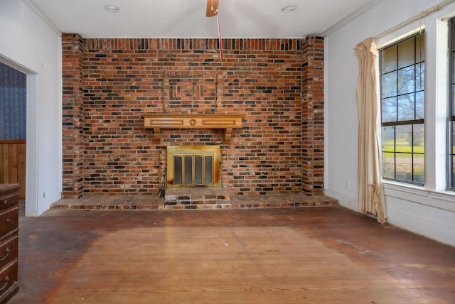 unfurnished living room featuring brick wall and wood finished floors