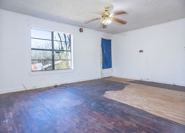 empty room with a textured ceiling, ceiling fan, hardwood / wood-style flooring, baseboards, and ornamental molding