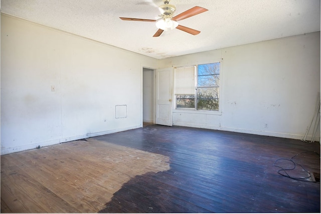 empty room with a textured ceiling, ceiling fan, wood finished floors, and baseboards