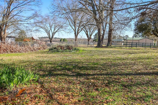 view of yard featuring fence and an outdoor structure