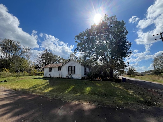 view of side of property with a yard