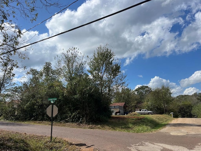 110 N Bolivar St, San Augustine, TX 75972 - view of asphalt road featuring traffic signs