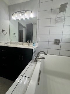 bathroom with a bathing tub and vanity
