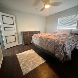bedroom featuring a ceiling fan and dark wood finished floors
