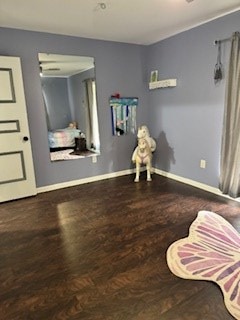 interior space featuring wood finished floors and baseboards