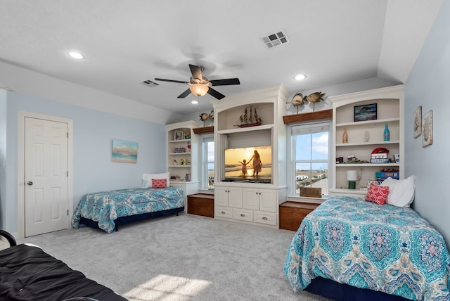 carpeted bedroom with ceiling fan and vaulted ceiling