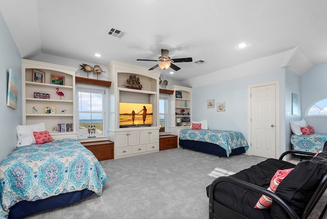 carpeted bedroom with ceiling fan and vaulted ceiling