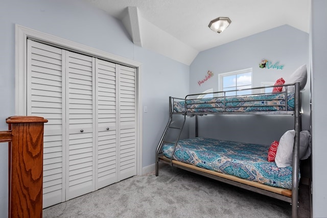 carpeted bedroom featuring vaulted ceiling